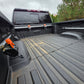 Truck bed tie down system